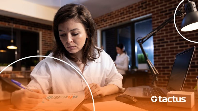 Imagem mostra mulher de negócios estudando documentos, para simular a importância de entender as mudanças da reforma tributária em 2026
